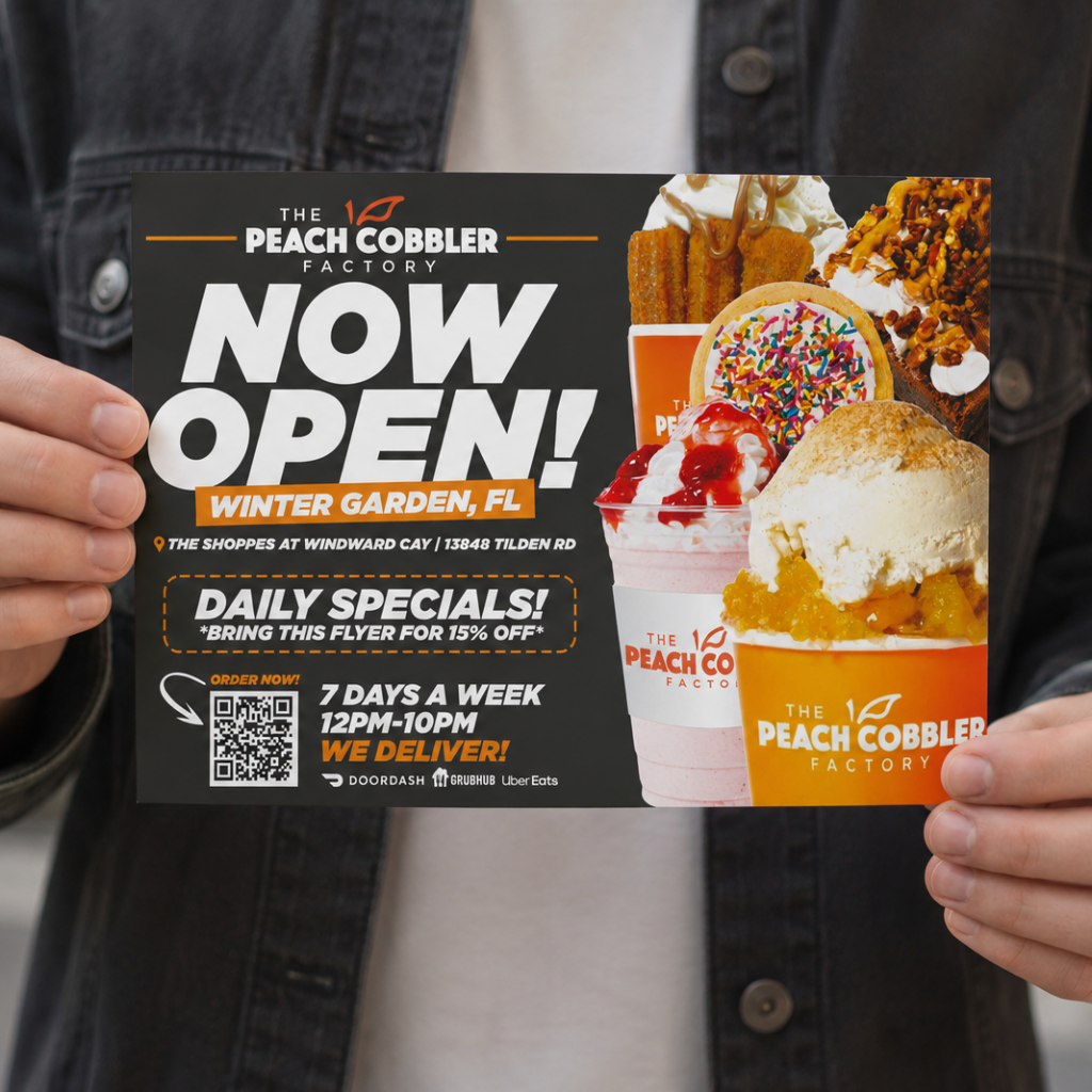 Person holding a promotional grand opening postcard designed for The Peach Cobbler Factory in Winter Garden, Florida.