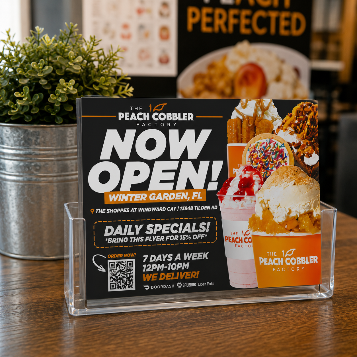 Peach Cobbler Factory promotional postcards displayed near a takeout pickup counter.